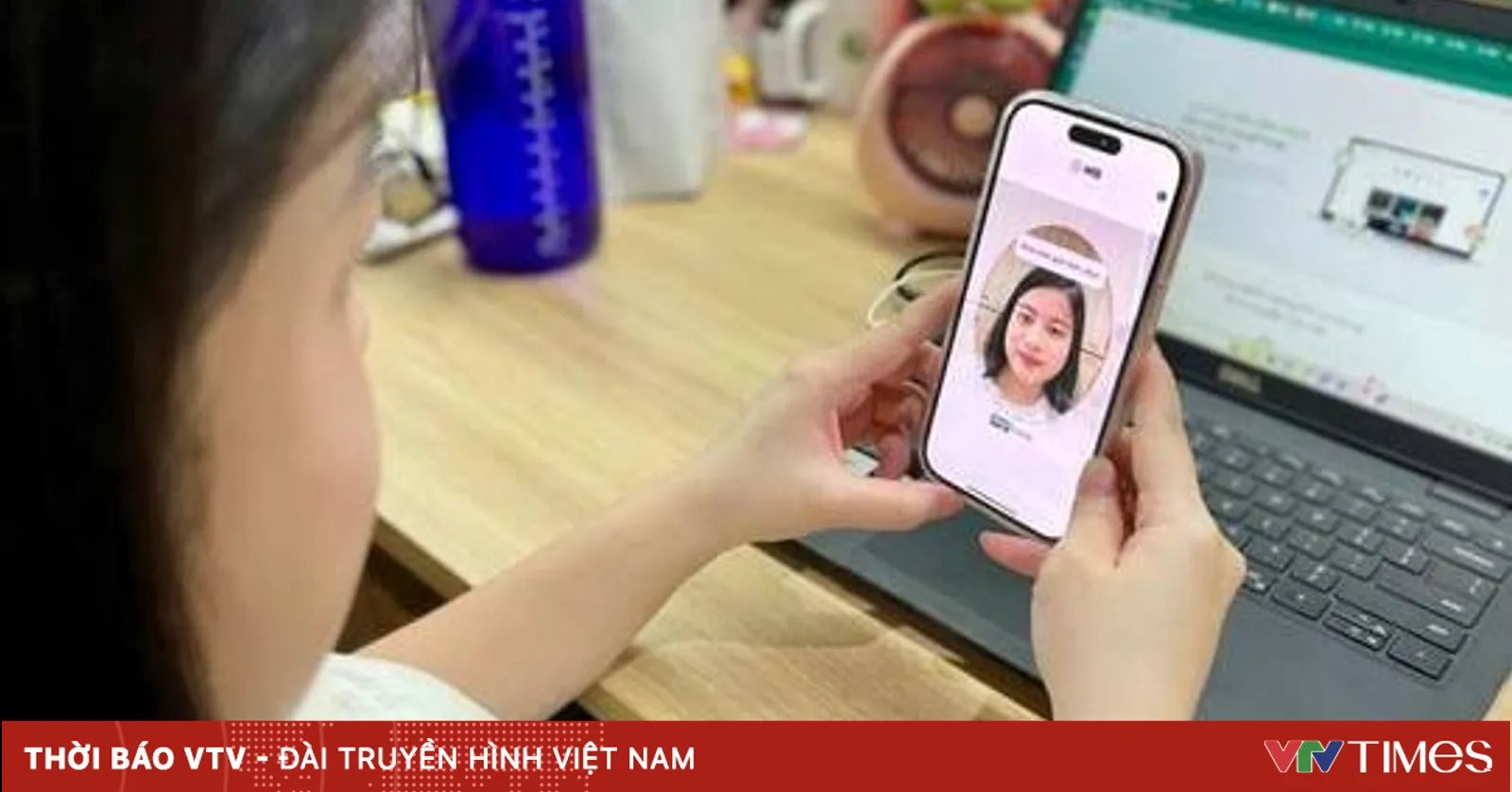 Nguoi dung cam dien thoai quet khuon mat de xac thuc lai thue bao sau khi doi may
